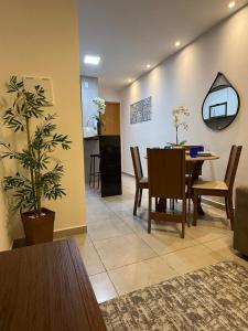 a living room with a table and a dining room at Park Cowboy - Valentina in João Pessoa