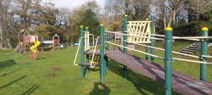 a playground with a slide in a park at BZ Green Haven Caravan in Ballantrae