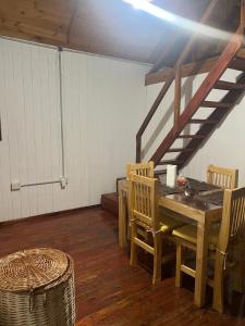 a dining room with a wooden table and chairs at Cabaña, Sol y Paz in Lima +8 photos