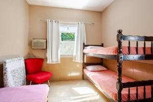 En eller flere senge i et værelse på Aluga-se casa por diarias