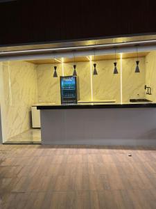 a lobby with a counter with a laptop on it at Honório Pousada-Caldas do Jorro BA in Tucano
