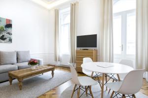 a living room with a couch and a table at HeyMi Apartments in City Center in Vienna