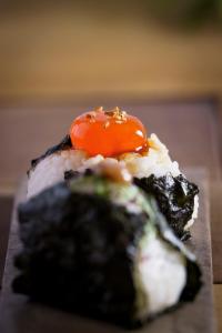 een stuk sushi met een tomaat erop bij 宿 ロイノハコ in Gotsu