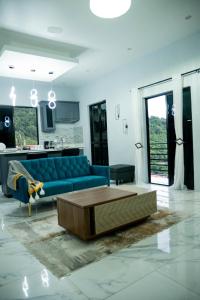 a living room with a blue couch and a coffee table at Hillside Haven in Kingston
