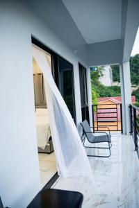 a room with a view of a bed and a balcony at Hillside Haven in Kingston