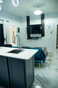 a kitchen with a sink and a tv on the wall at Hillside Haven in Kingston