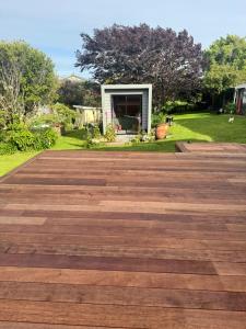 a large wooden deck in front of a yard at Harbourview Hideaway in Riverton