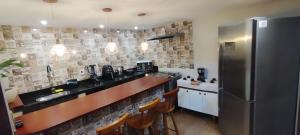 a kitchen with a stainless steel refrigerator at Doce lar in Búzios