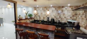 a bar in a restaurant with a counter and chairs at Doce lar in Búzios +16 photos
