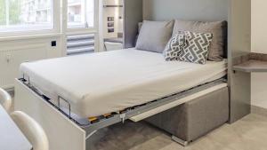 a large bed in a room with a bed frame at AR Rezidencia Rosná in Košice