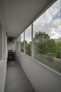 an empty hallway with a chair and a window at AR Rezidencia Rosná in Košice
