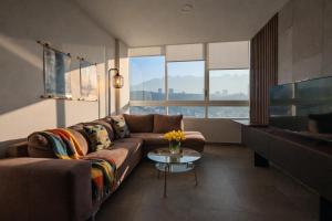 a living room with a couch and a table at Stylish Panoramic Views City Loft in Monterrey +7 photos
