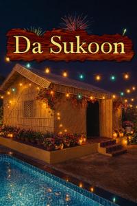 a swimming pool in front of a building with a sign at Da Sukoon in Pachār