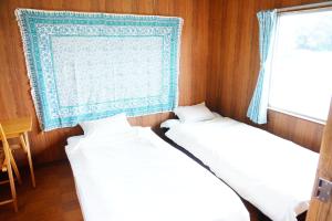 En eller flere senge i et værelse på こころからだつながるお宿あんたんげ