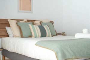 a bedroom with a bed with pillows on it at Increíble estudio boutique con vista al mar Mediterráneo in Benalmádena +18 photos