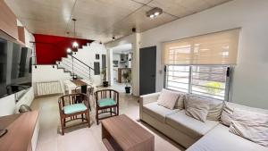 a living room with a couch and a table at Casa Bouchard in Valeria del Mar