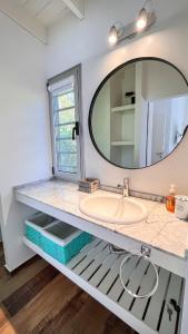 a bathroom with a sink and a mirror at Casa Bouchard in Valeria del Mar