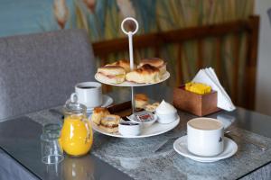 a table with two plates of pastries and orange juice at Hostería Antu Kuyen in San Carlos de Bariloche