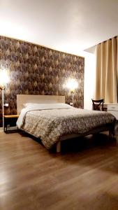 a bedroom with a bed with a stone wall at Apparemment Nawé in Tarbes