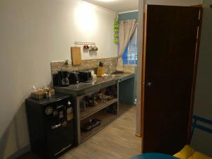 a small kitchen with a counter and a sink at Tercer Cielo in Mejillones