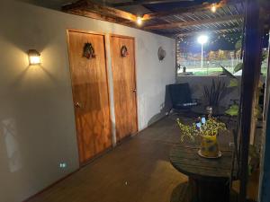 a room with a table and a wooden door at Tercer Cielo in Mejillones