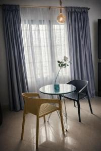 a table with chairs and a vase with a flower on it at Wiky House Guaduas in Guaduas