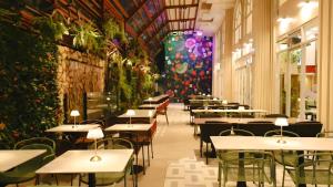 a restaurant with tables and chairs and plants at Wright Park Hotel in Baguio