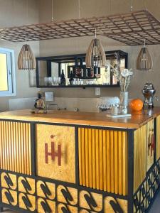 a kitchen with a large yellow and brown counter at Hotel Ideal vcp in Villa Carlos Paz