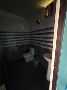 a bathroom with a toilet and a sink at Rudraksh Hotel And Restaurant in Amgarhi