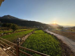 a view of a field with the sun in the background at Rudraksh Hotel And Restaurant in Amgarhi