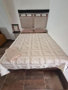 a bed sitting in a room with at Mi casa en Sucre in Sucre +2 photos