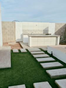 a building with a garden with grass and stepping stones at casa estefania in San Carlos