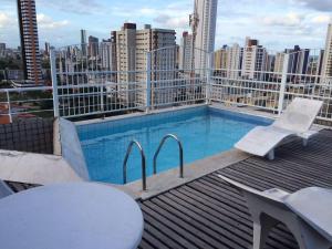 a swimming pool on the roof of a building at Flat Manaira, lado do Manaira Shopping in João Pessoa