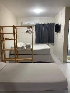 a room with three beds in a room at Flat Manaira, lado do Manaira Shopping in João Pessoa +15 photos