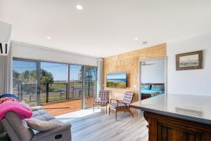 a kitchen and living room with a table and chairs at Lees Dream in Venus Bay