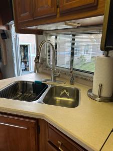 a kitchen counter with a sink and a window at Comfortable and cozy RV in Lehigh Acres +41 photos