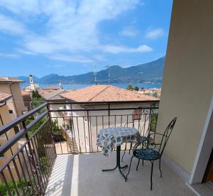 a patio with a table and chairs on a balcony at Apartment with great views on Lake Garda in Torri del Benaco