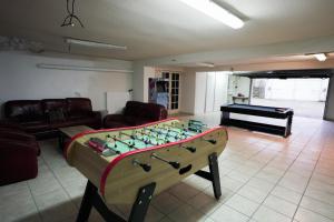 a room with a foosball table in front of a living room at Villa Mandalika in Noisy-le-Grand +14 photos