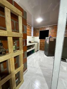 a kitchen with a brick wall and a refrigerator at The Magical Garden in Cali