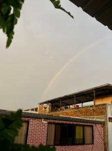 a rainbow on top of a brick building at The Magical Garden in Cali