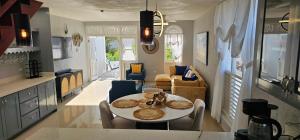 a kitchen and living room with a table and chairs at Paradise View- Oceanfront Oasis in Runaway Bay