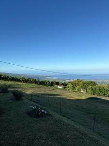 a field with a fence and a view of the ocean at Lodge Plateau 2 in La Possession