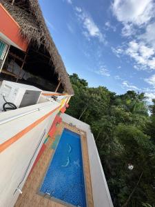 a swimming pool on the side of a house at Healing Home Unity Thilo Guest House in Puducherry