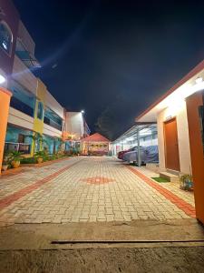 a cobblestone street in a city at night at Healing Home Unity Thilo Guest House in Puducherry +16 photos