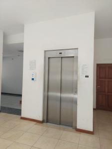 a metal elevator in a building with a door at Mirasol in Villa Carlos Paz