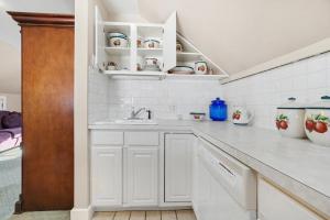 a kitchen with white cabinets and a sink at The Manheim Manor in Manheim +44 photos