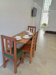 a wooden table and chairs in a living room at Mi casa en Sucre in Sucre
