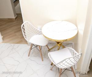 a white table and two chairs in a room at Mupa Luxury Condo IV BnB in Nyahururu +18 photos