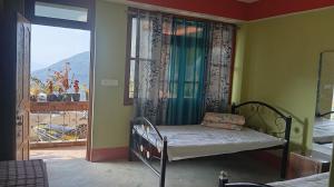 a bedroom with a bed and a window with a view at K2k homestsy in Rhenok +6 photos