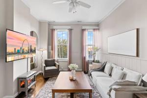 a living room with a couch and a table at The Bricklight | Elevated 3BR + Parking in Soulard in Saint Louis